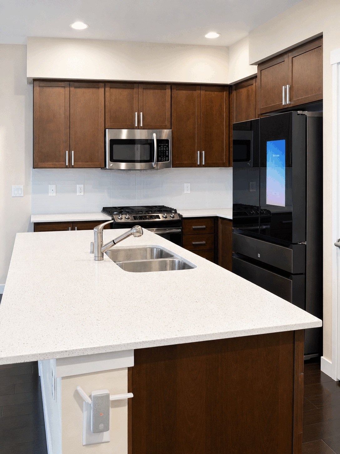 Clean empty kitchen with bright island and polished surfaces